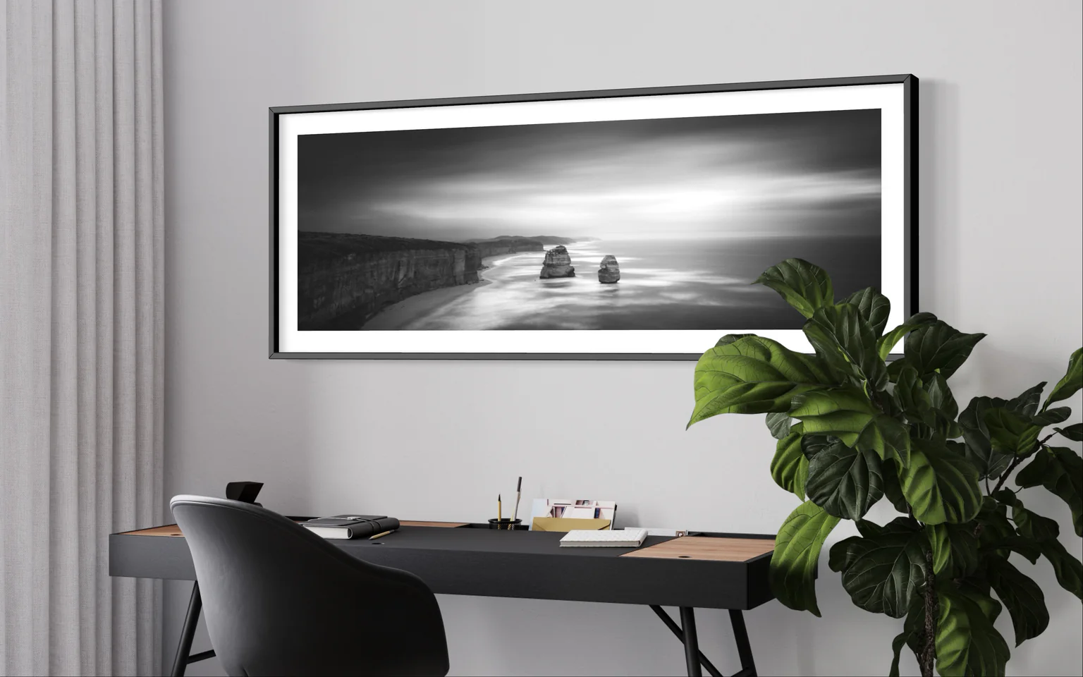 Framed panoramic landscape print displayed in a home office